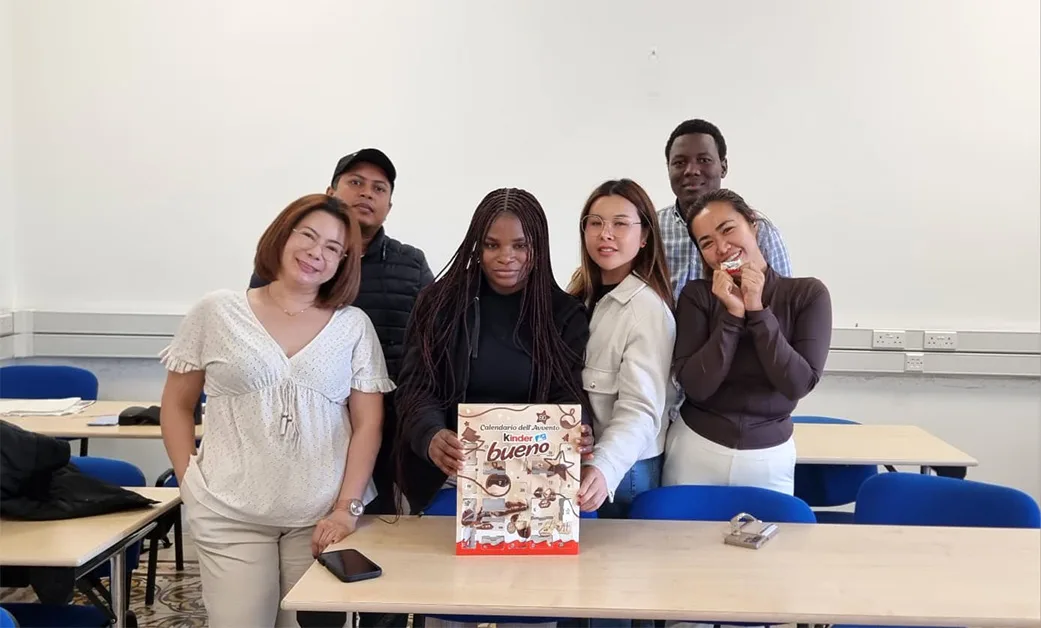 Students posing together in a classroom at Ascencia Malta during student highlight session
