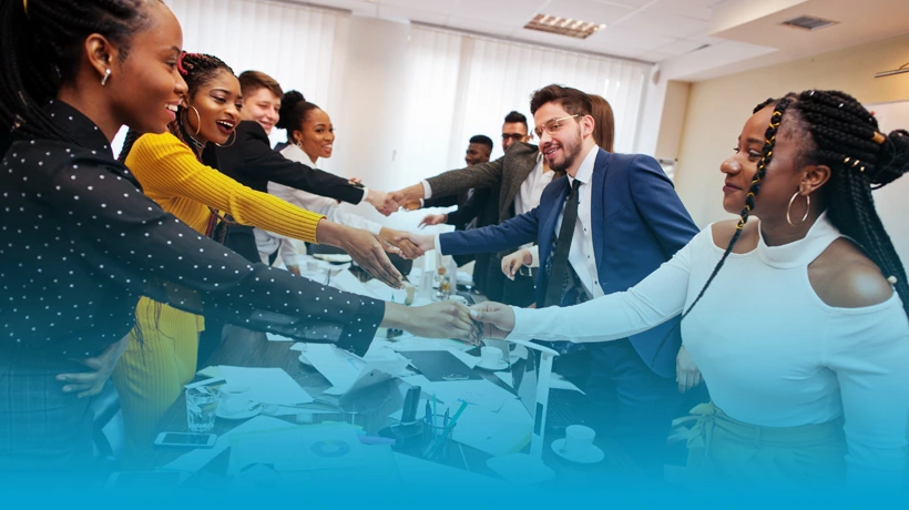Entrepreneurs shaking hands during a business meeting in an English for Specific Purposes (ESP) Entrepreneurship course.