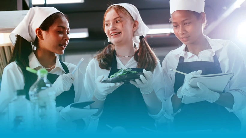Students in chef uniforms preparing food during an English for Specific Purposes (ESP) Catering course focused on hospitality communication in Malta